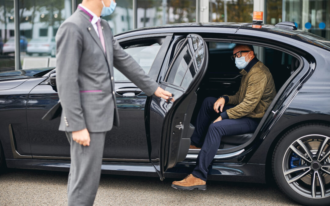 Chauffeur,Opening,The,Car,Door,For,A,Caucasian,Male,Passenger